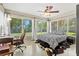 Sunlit bedroom featuring large windows, a ceiling fan, and comfortable bed at 1324 Augusta S Ln, St Petersburg, FL 33707