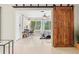 Bright bedroom featuring a modern design with a large window, desk, and striking sliding barn doors at 1324 Augusta S Ln, St Petersburg, FL 33707