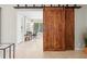 Bedroom featuring a modern design with a large window, desk, and striking sliding barn doors at 1324 Augusta S Ln, St Petersburg, FL 33707