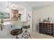 Cozy breakfast bar area with pendant lighting, bar stools, and plenty of natural light overlooking the yard at 1324 Augusta S Ln, St Petersburg, FL 33707