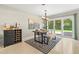 Dining room with modern light fixture, decorative rug, and sliding glass doors to the outdoor space at 1324 Augusta S Ln, St Petersburg, FL 33707