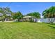 Quaint home with expansive lawn, complemented by lush tropical landscaping at 1324 Augusta S Ln, St Petersburg, FL 33707