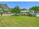 Charming home with a well-manicured lawn, lush landscaping, and a white picket fence at 1324 Augusta S Ln, St Petersburg, FL 33707