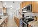 A well-lit kitchen with modern appliances, wood cabinets, and stylish countertops at 1324 Augusta S Ln, St Petersburg, FL 33707