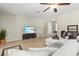 Inviting living room features terrazzo floors, modern furnishings, neutral paint, and plenty of natural light at 1324 Augusta S Ln, St Petersburg, FL 33707
