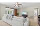 Spacious living room with comfortable seating, a ceiling fan, and stylish decor at 1324 Augusta S Ln, St Petersburg, FL 33707