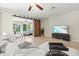 Bright living room boasts polished floors, comfortable seating, barn door entry to the bedroom, and natural light at 1324 Augusta S Ln, St Petersburg, FL 33707