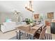 Open living space features dining area, living room, and a breakfast bar with views of the kitchen at 1324 Augusta S Ln, St Petersburg, FL 33707