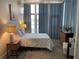 Well-lit bedroom with a patterned bedspread and stylish curtains offers a comfortable and inviting space at 1345 2Nd St, Sarasota, FL 34236