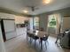 Bright break room includes a dining table, white appliances, and natural light at 1345 2Nd St, Sarasota, FL 34236