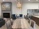 Elegant dining area with modern fireplace, seating and access to kitchen with stainless appliances at 1345 2Nd St, Sarasota, FL 34236