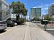 A street view of the complex featuring plenty of parking and lush landscaping at 1345 2Nd St, Sarasota, FL 34236