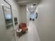 Hallway with art, stylish chair, wood floors, and tasteful decor at 1345 2Nd St, Sarasota, FL 34236