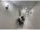 Hallway with stylish seating, white walls, wood floors, decorative ceiling, and tasteful decor at 1345 2Nd St, Sarasota, FL 34236