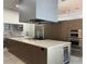 Modern kitchen with stainless steel appliances, spacious island, and sleek cabinetry with generous counter space at 1345 2Nd St, Sarasota, FL 34236