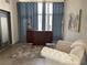 Stylishly staged living room features a wooden bar and decorative accents with a comfortable white chair at 1345 2Nd St, Sarasota, FL 34236