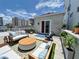 A rooftop patio with outdoor seating provides a relaxing space with city views and blue skies at 1345 2Nd St, Sarasota, FL 34236