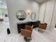 Salon space with stylist stations, mirrors, salon chairs and modern minimalist design at 1345 2Nd St, Sarasota, FL 34236