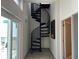 Unique spiral staircase bathed in natural light, connecting levels with style and elegance at 1345 2Nd St, Sarasota, FL 34236