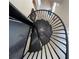 Unique spiraling staircase with black metal finish offers a modern design element to the home at 1345 2Nd St, Sarasota, FL 34236
