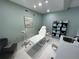 A bright treatment room featuring modern furniture, light green walls and a massage table at 1345 2Nd St, Sarasota, FL 34236