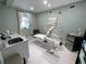 A bright treatment room featuring modern furniture, light green walls and a massage table at 1345 2Nd St, Sarasota, FL 34236