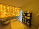 Treatment room featuring a bed, soft lighting, equipment, and unique illuminated block wall at 1345 2Nd St, Sarasota, FL 34236