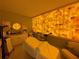 Bright treatment room featuring a bed, soft lighting, equipment, and unique illuminated block wall at 1345 2Nd St, Sarasota, FL 34236