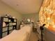 Treatment room with a bed, cabinets, equipment, and unique illuminated block wall at 1345 2Nd St, Sarasota, FL 34236