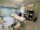 Bright room featuring equipment, treatment bed, cabinets, and soft natural lighting at 1345 2Nd St, Sarasota, FL 34236