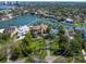 Aerial view showcases an expansive waterfront property with a tennis court, lush landscaping, and a luxurious home at 1423 & 1435 Hillview Dr, Sarasota, FL 34239