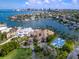 Waterfront estate featuring lush landscaping, a private dock, and a blue sport court at 1423 & 1435 Hillview Dr, Sarasota, FL 34239