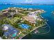 Stunning waterfront property with a tennis court, private dock, lush greenery, and a beautiful home overlooking the water at 1423 & 1435 Hillview Dr, Sarasota, FL 34239