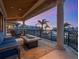 This outdoor balcony features a fire pit, comfortable seating, and serene views of the surrounding waterfront landscape at 1423 & 1435 Hillview Dr, Sarasota, FL 34239