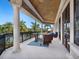 Enjoy picturesque views from this open balcony with stylish seating and decorative columns, perfect for relaxing outdoors at 1423 & 1435 Hillview Dr, Sarasota, FL 34239
