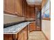 Elegant bar area features custom cabinetry, granite countertops, a wine fridge, and wood floors at 1423 & 1435 Hillview Dr, Sarasota, FL 34239