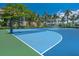 Outdoor basketball court with palm trees and lush landscaping under a bright blue sky at 1423 & 1435 Hillview Dr, Sarasota, FL 34239