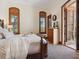 Bedroom featuring neutral walls, carpet, and wood-framed windows and doors with access to an outdoor space at 1423 & 1435 Hillview Dr, Sarasota, FL 34239