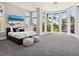 Bright bedroom with a large curved window offering scenic outdoor views and natural light at 1423 & 1435 Hillview Dr, Sarasota, FL 34239