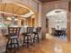 Open floorplan showcasing kitchen bar and breakfast nook with hardwood floors and a large chandelier at 1423 & 1435 Hillview Dr, Sarasota, FL 34239