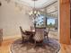 Elegant dining room with chandelier and large windows showcasing the beautiful landscaping at 1423 & 1435 Hillview Dr, Sarasota, FL 34239