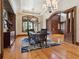 Formal dining room with arched entry, wood floors, and natural light at 1423 & 1435 Hillview Dr, Sarasota, FL 34239