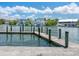 Private wooden dock showcasing serene waterfront views under a cloudy blue sky at 1423 & 1435 Hillview Dr, Sarasota, FL 34239