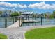 Private dock with boat lift and beautiful waterfront views under a cloudy blue sky at 1423 & 1435 Hillview Dr, Sarasota, FL 34239