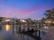 Private wooden dock overlooking serene waterfront views under a colorful dusk sky at 1423 & 1435 Hillview Dr, Sarasota, FL 34239