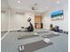 Bright exercise room with modern equipment, mats, and a mirror wall for home workouts at 1423 & 1435 Hillview Dr, Sarasota, FL 34239