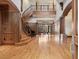 Expansive foyer showcasing a curved staircase, hardwood floors, and sophisticated architectural details at 1423 & 1435 Hillview Dr, Sarasota, FL 34239