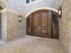 Elegant arched double doors with sidelights, complemented by brickwork and stylish outdoor sconces at 1423 & 1435 Hillview Dr, Sarasota, FL 34239