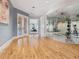 Bright hallway leads to an exercise room with a glass wall, offering a glimpse of the active space at 1423 & 1435 Hillview Dr, Sarasota, FL 34239