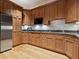 Kitchen area featuring wood cabinetry, stainless steel appliances and tile backsplash at 1423 & 1435 Hillview Dr, Sarasota, FL 34239